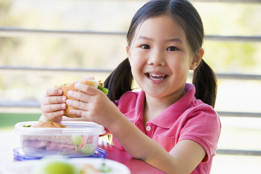 Girl eating lunch at kindergarten